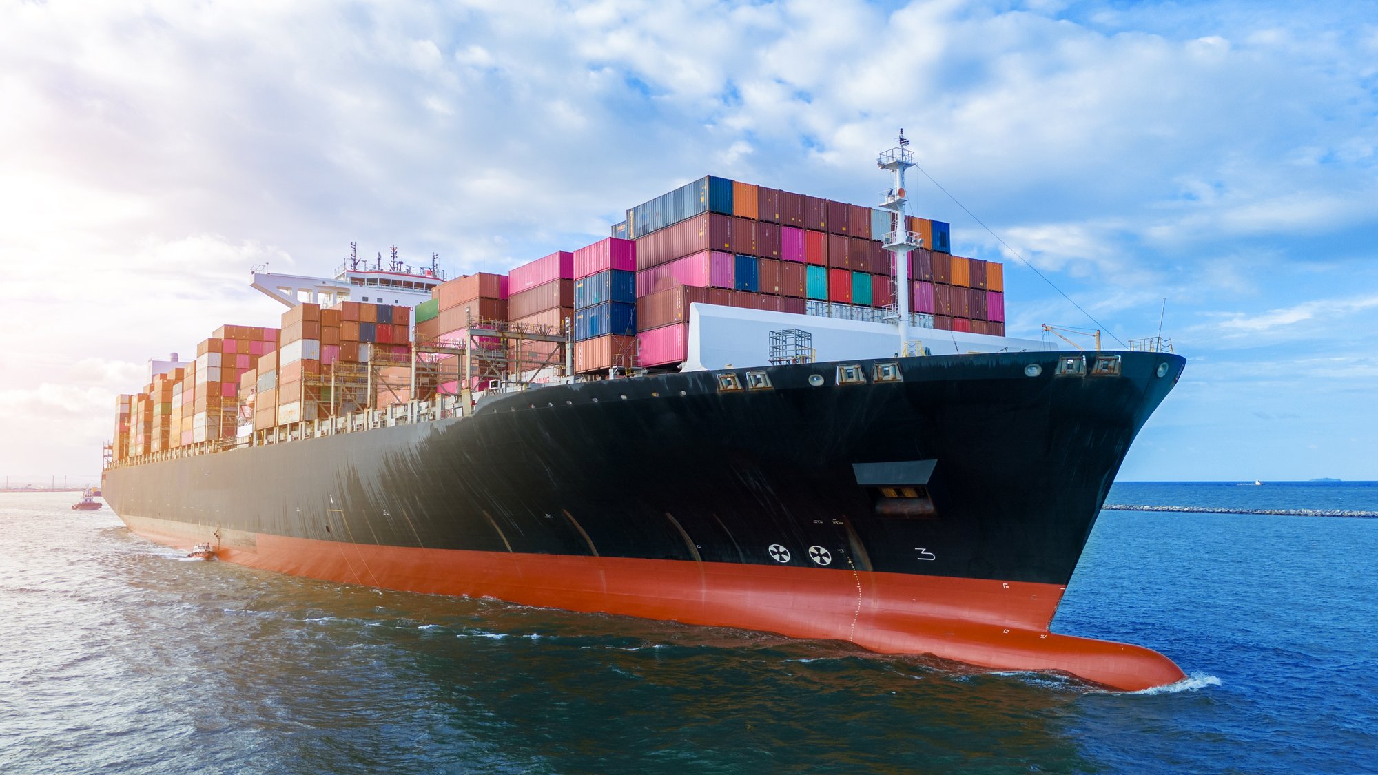 Cargo ship loaded with containers at sea, representing global commodity trade
