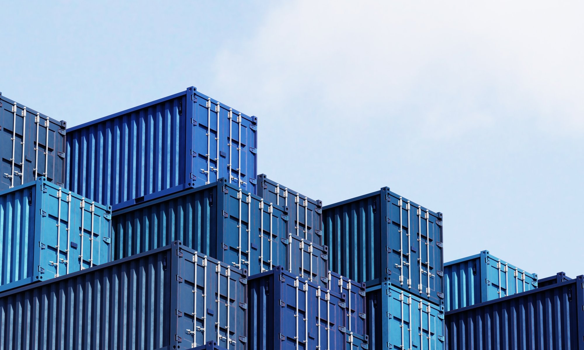 Stacked shipping containers representing global freight and logistics