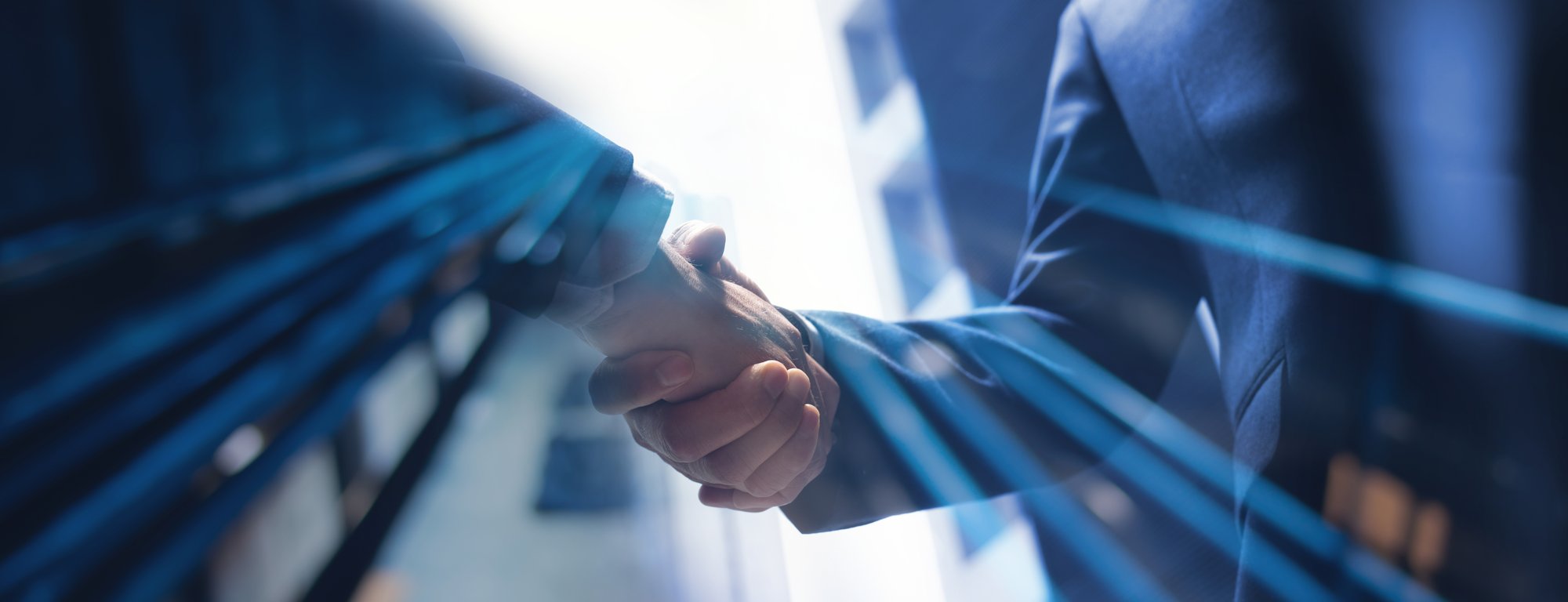 Two business professionals shaking hands, sealing a partnership